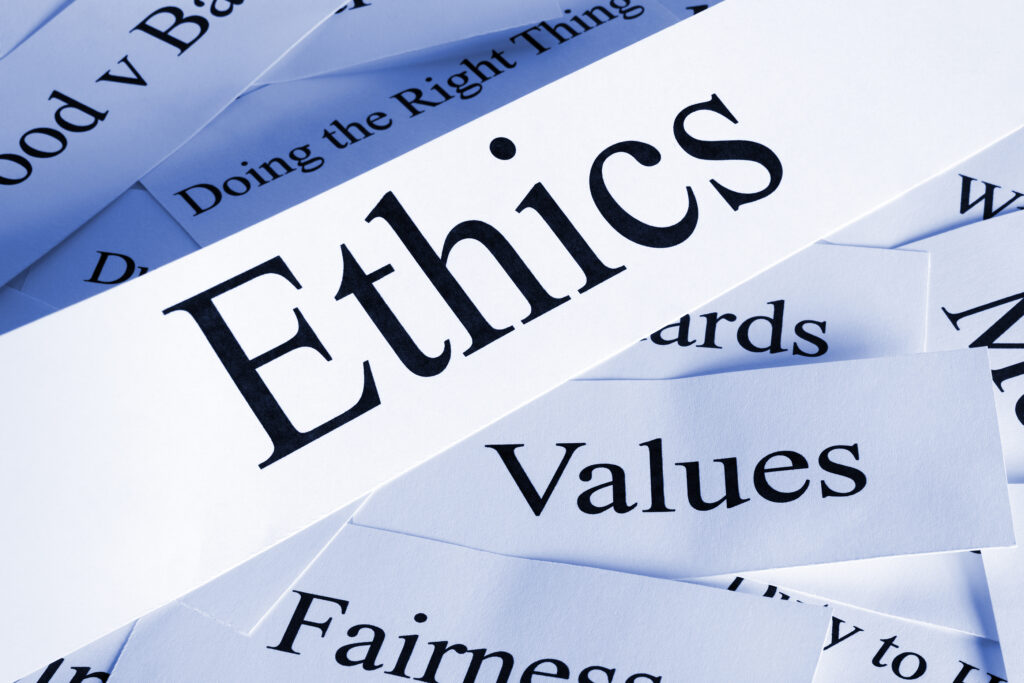 Slips of paper with buzzwords like "ethics" "values" "fairness" and more are strewn about.