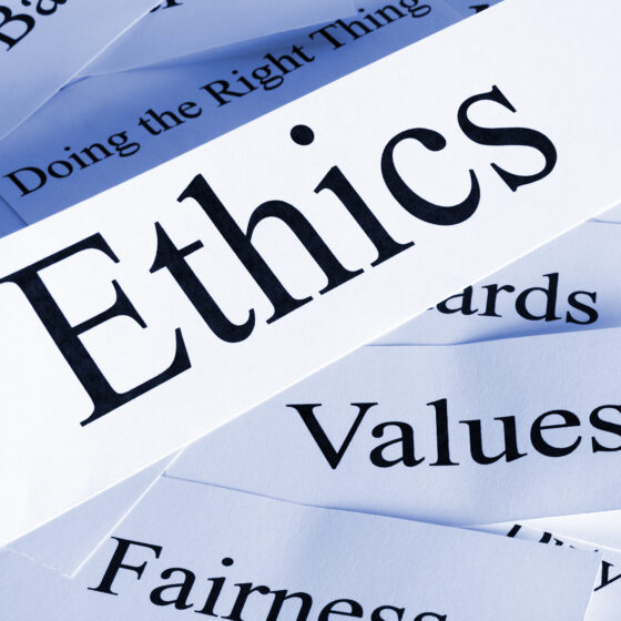 Slips of paper with buzzwords like "ethics" "values" "fairness" and more are strewn about.
